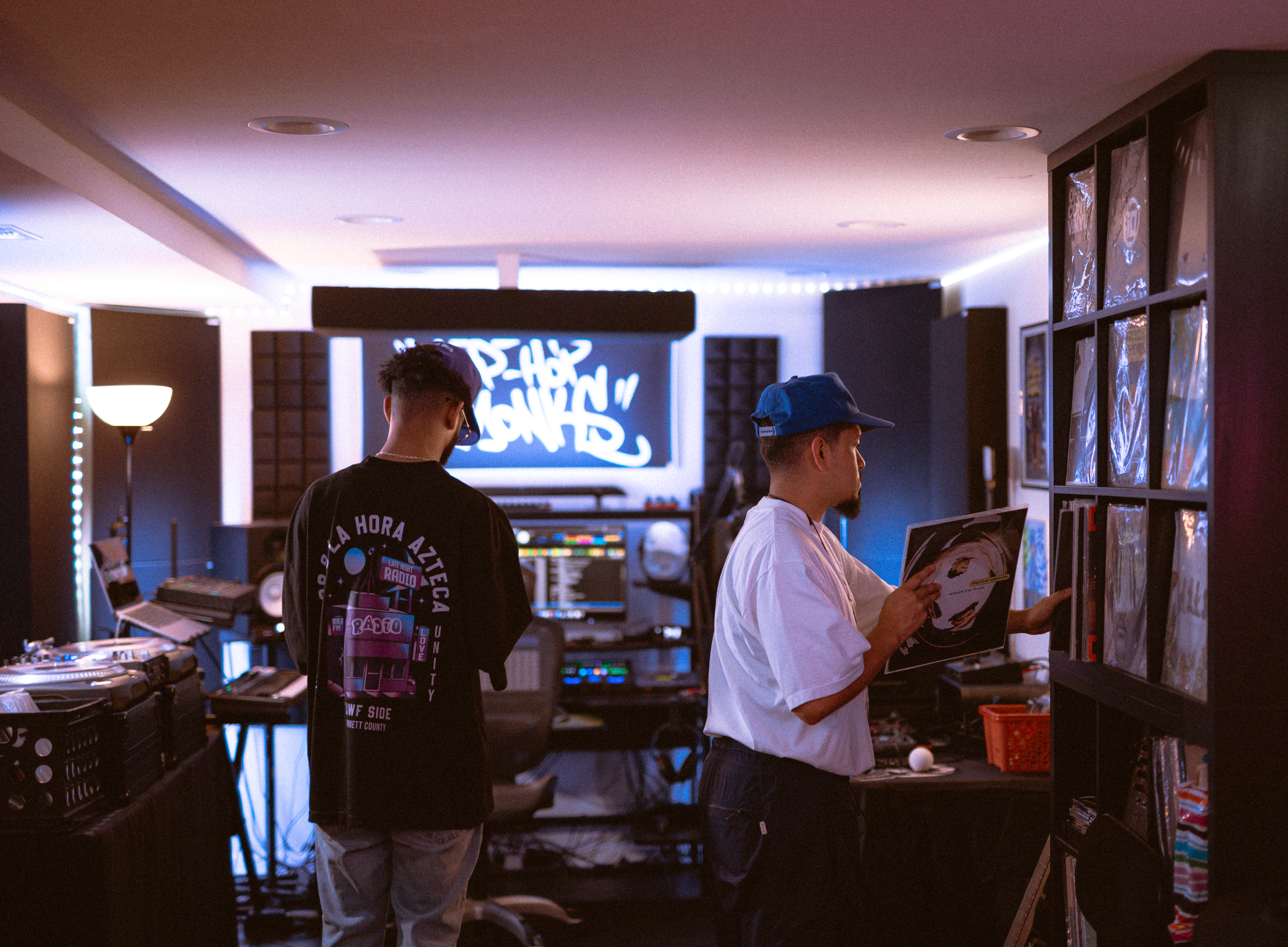 Artists selecting records during a creative session at Dojo Studios
